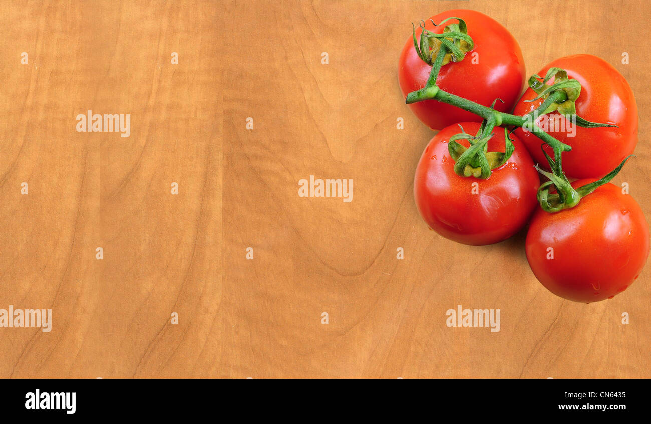 Il ramo di pomodori freschi sulla tavola di legno Foto Stock
