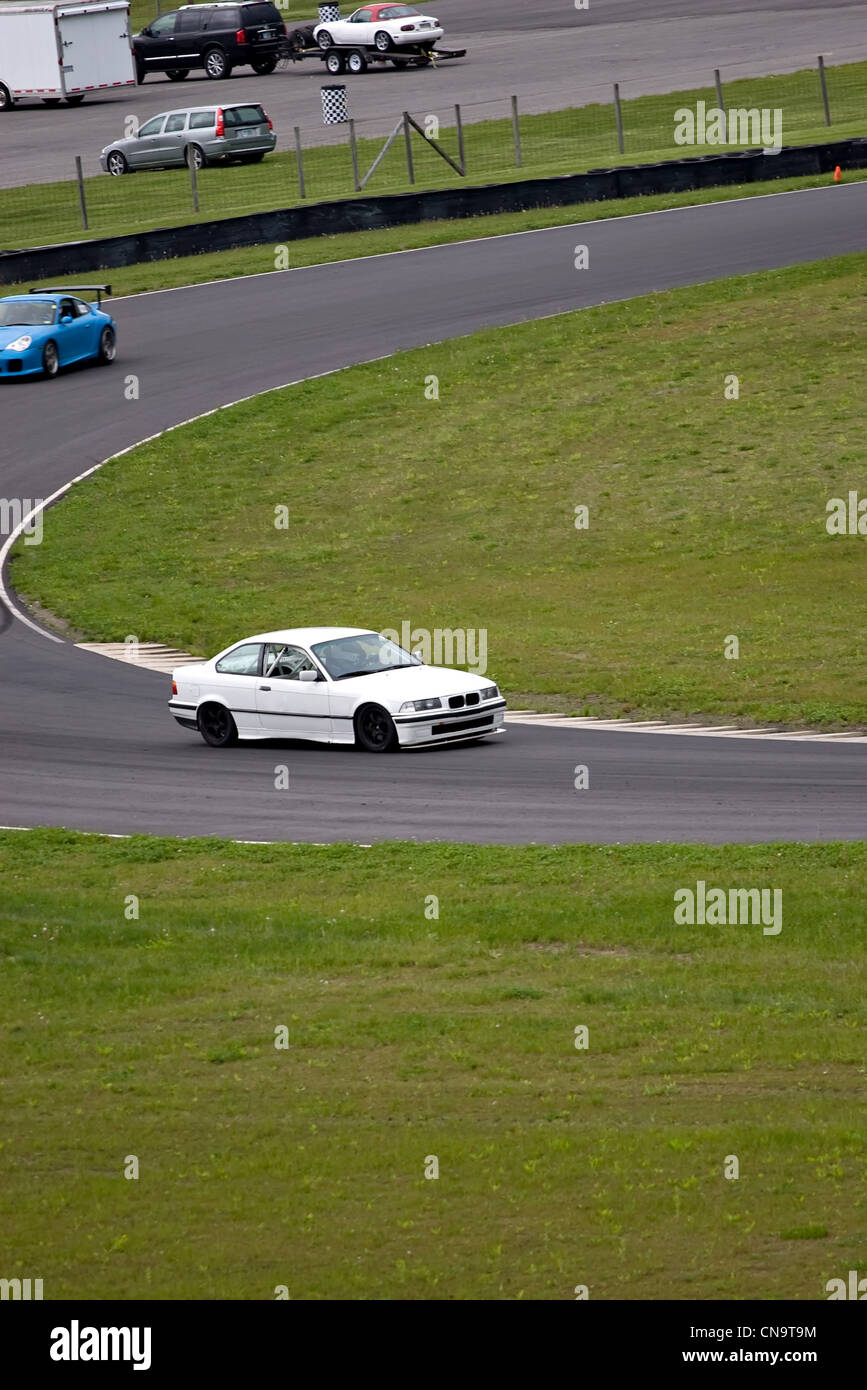 Sports Car racing intorno a un corso su strada a velocità intensa. Foto Stock