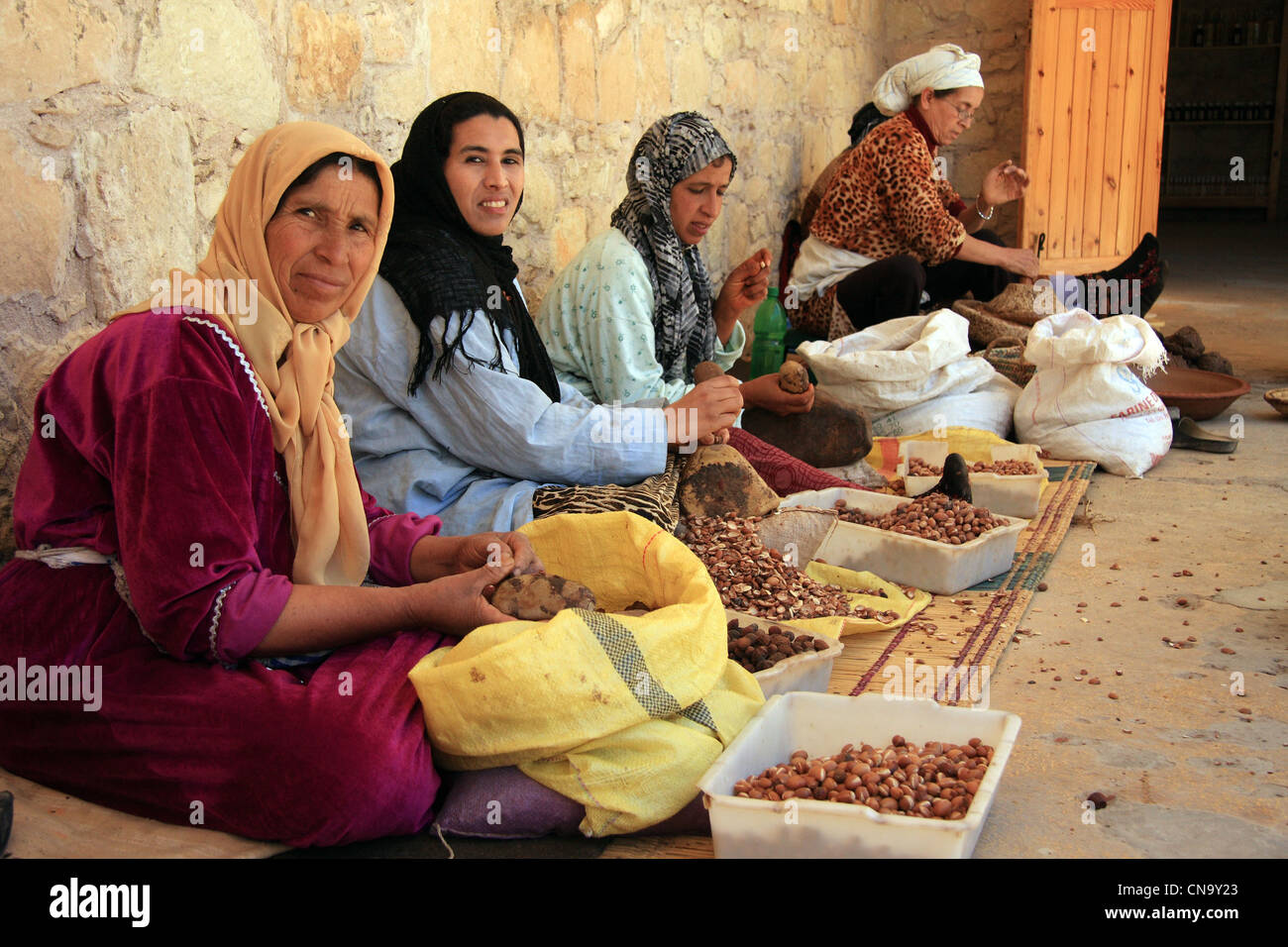 Donne berbere di estratto di olio di Argan dal dado di Argan kernals a Assous Argane co-operativa nei pressi di Essaouira, a sud-ovest del Marocco Foto Stock