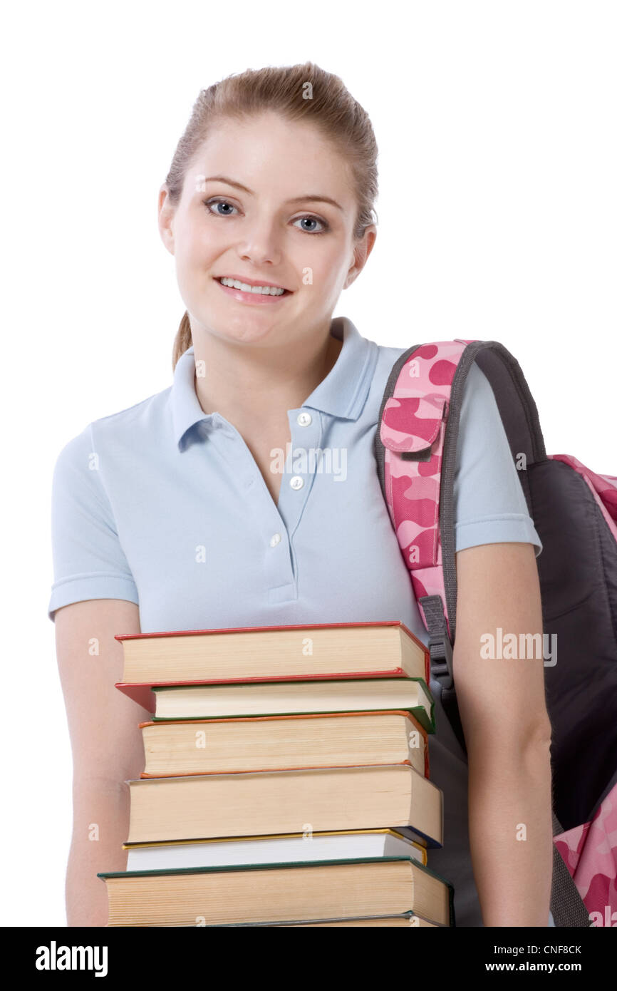 Giovane femmina caucasica studente di college in jeans con zaino azienda enorme pila di libri educativi da libreria Foto Stock