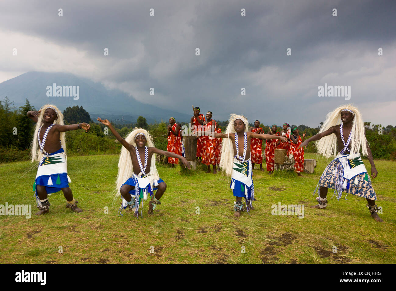 L'Africa. Il Ruanda. I giovani danzatori Hutu presso il Gorilla di Montagna View Lodge vicino a Ruhengeri e vulcani NP con Mt Sabinyo. (MR) Foto Stock