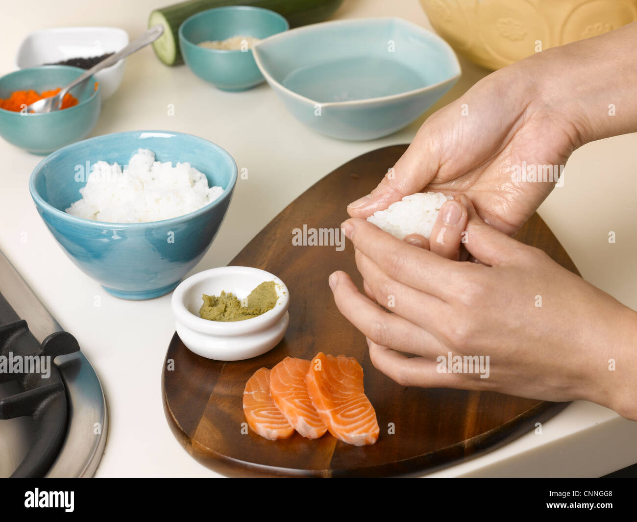 La donna prepara sushi a tavola Foto Stock