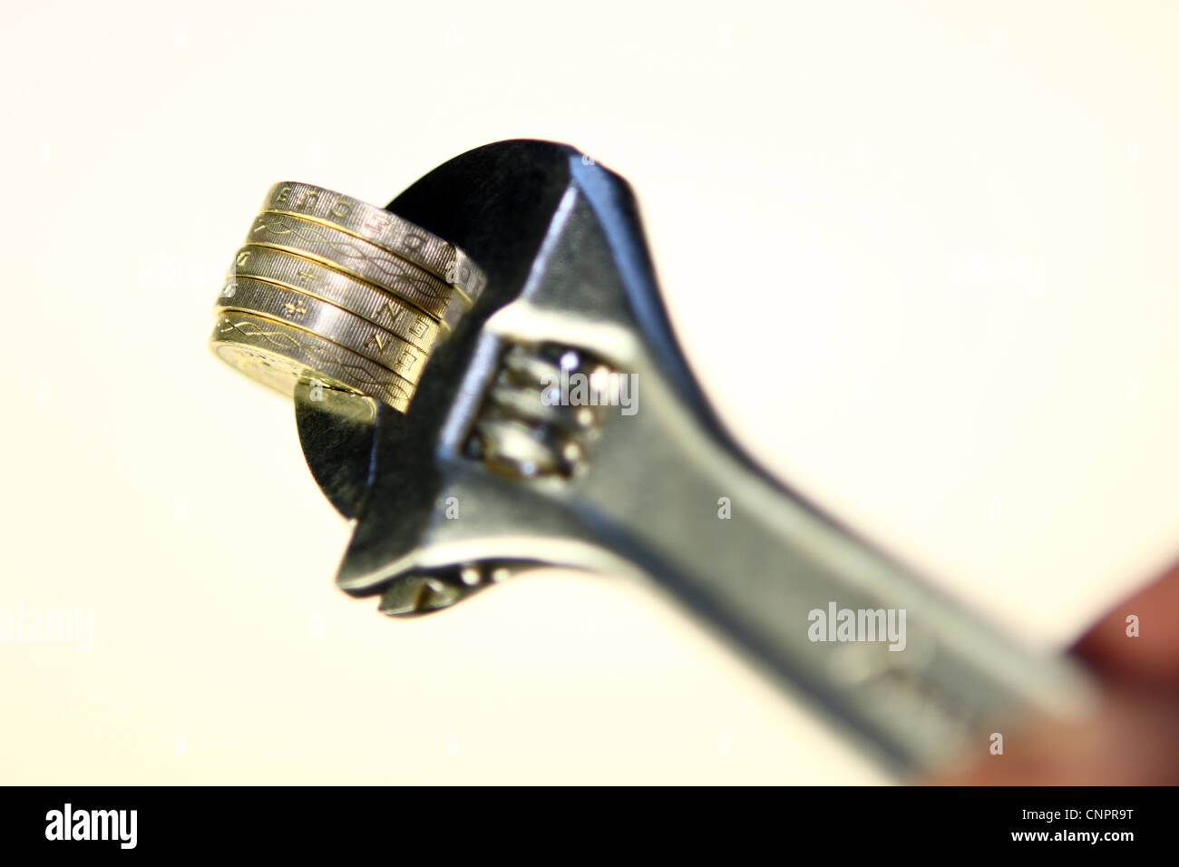£ 1 monete tra le ganasce di una chiave Foto Stock