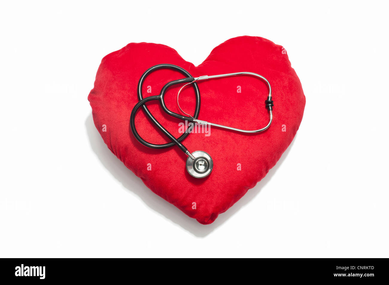 Uno stetoscopio in un cuore rosso Cuscino sagomato Foto Stock
