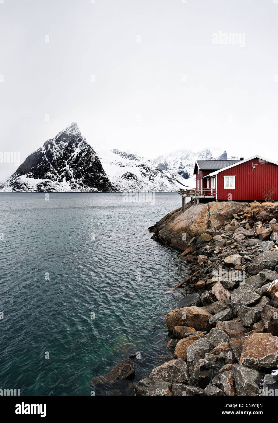 Un rorbu o dei pescatori del rifugio sulla costa vicino a Hamnoy, con Olstind mountain in background Foto Stock