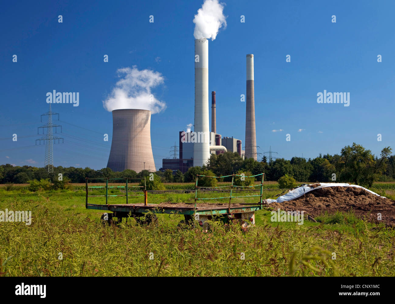 Veicolo agricolo in un pascolo con le centrali a carbone Voerde, in Germania, in Renania settentrionale-Vestfalia, la zona della Ruhr, Voerde Foto Stock