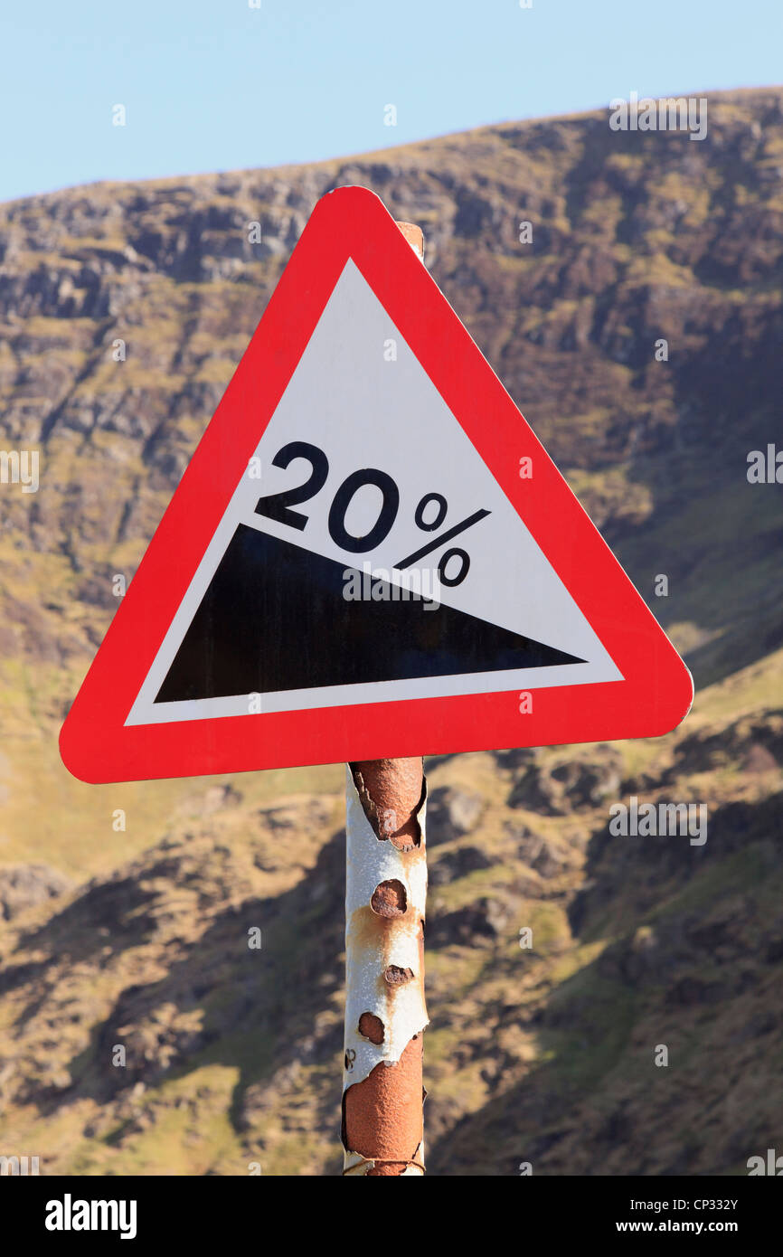 Triangolo rosso forte pendenza 20% di pendenza segno di avvertimento su una strada di montagna in montagna. Newlands Pass, Cumbria, England, Regno Unito Foto Stock