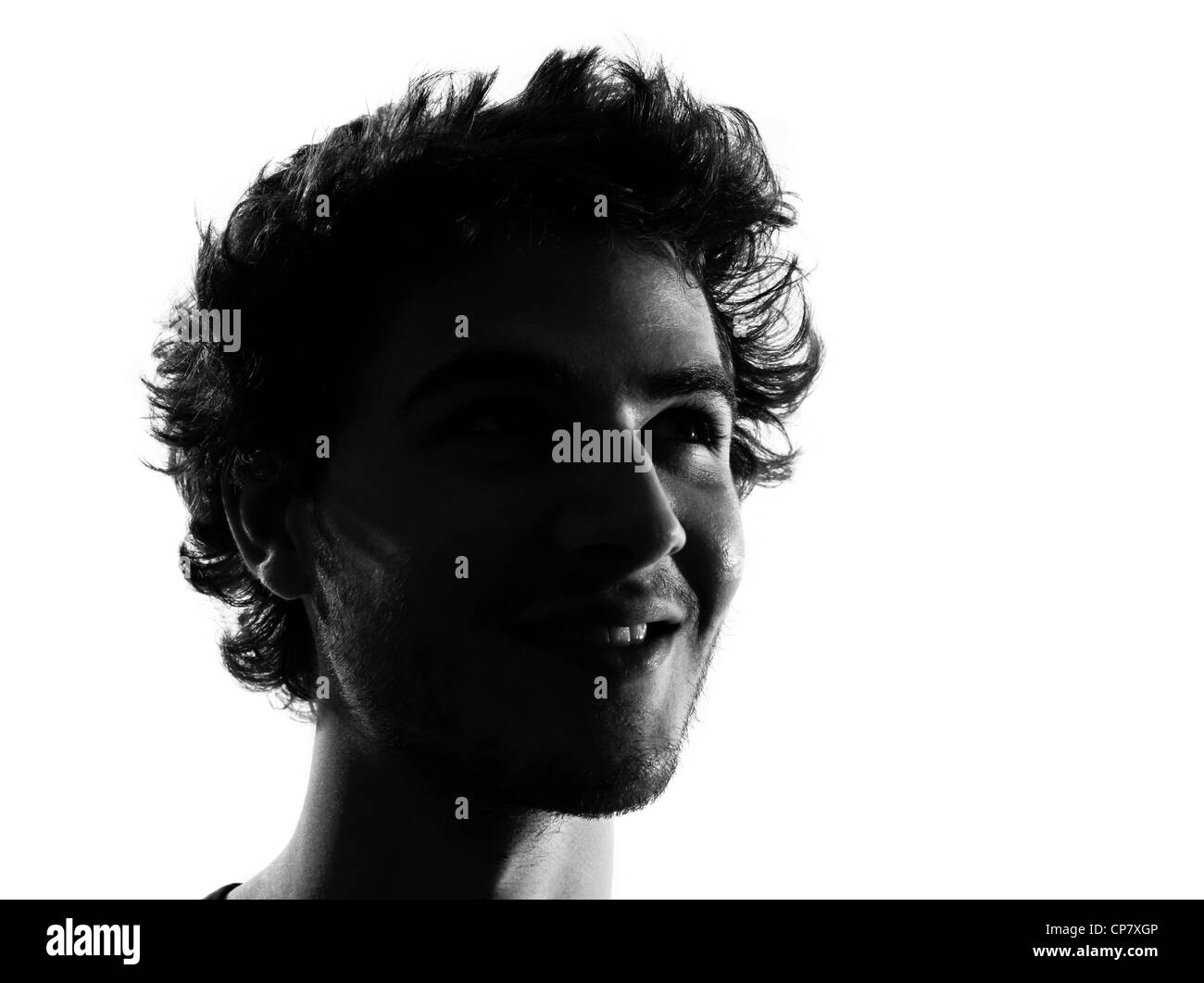 Giovane uomo cerca su ritratto silhouette in studio isolato su sfondo bianco Foto Stock