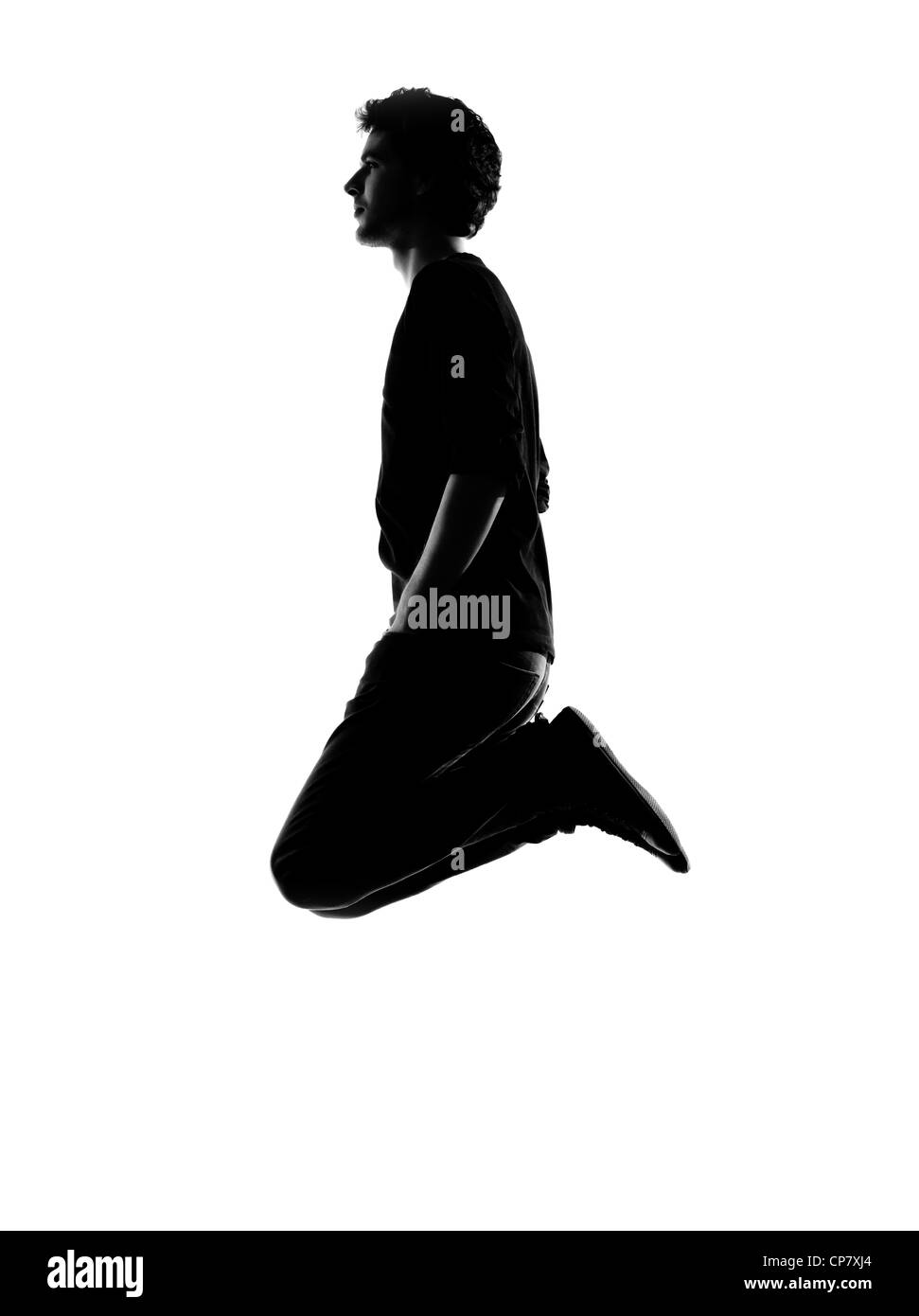Giovane uomo funny jumping silhouette in studio isolato su sfondo bianco Foto Stock