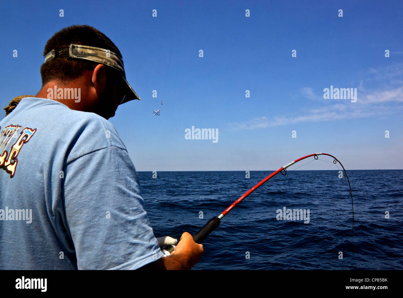 Pescatore caucasica la riproduzione di pesci nell'offshore profondo mare aquilone sport pesca Golfo del Messico Foto Stock