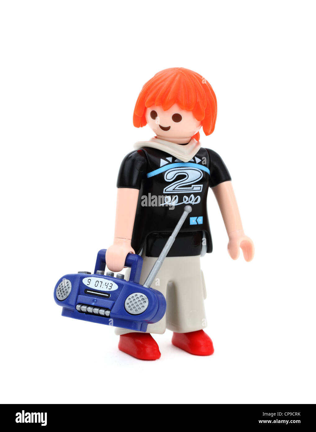 Playmobil toy la figura di un adolescente ragazza con i capelli rossi che porta una radio. Foto Stock