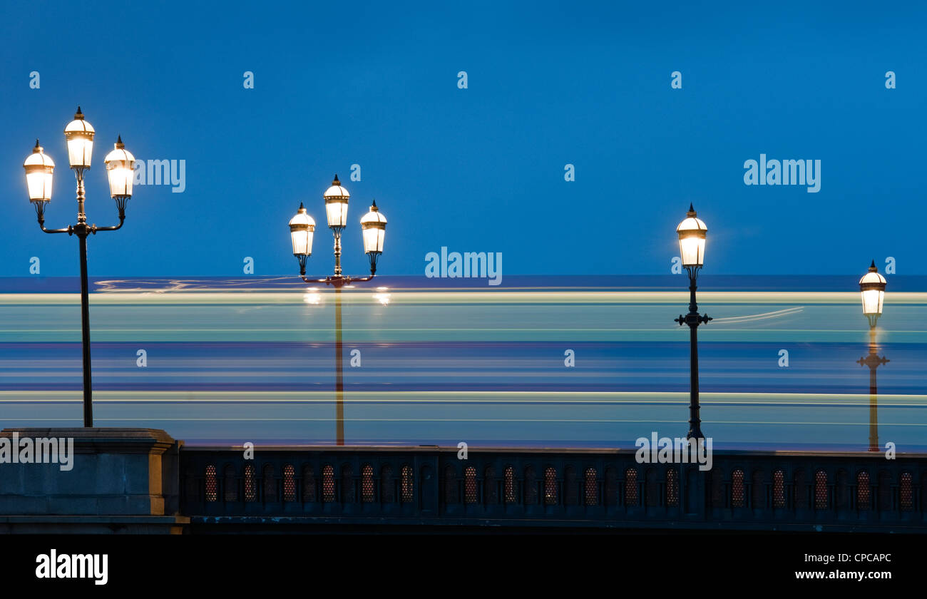 Lampade in stile vittoriano sul ponte di Battersea, Londra con luce sentiero da traffico passante creazione immagine astratta Foto Stock