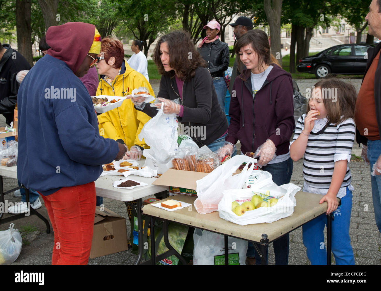 Detroit, Michigan - Volontari feed senzatetto da tabelle configurate nel Parco Cass. Foto Stock