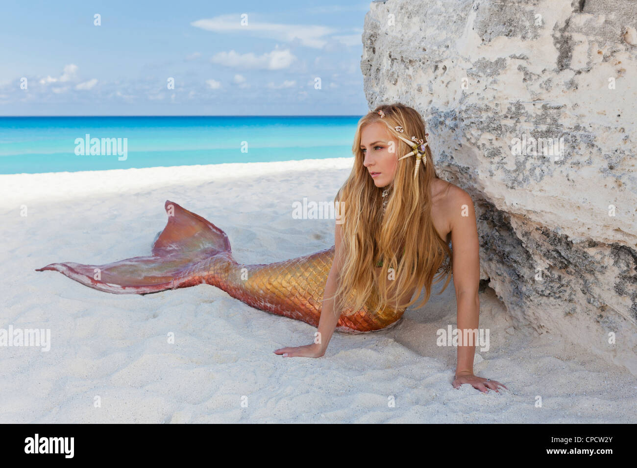 Giovane biondo mermaid recante sulla spiaggia di Cancun, Messico Foto Stock