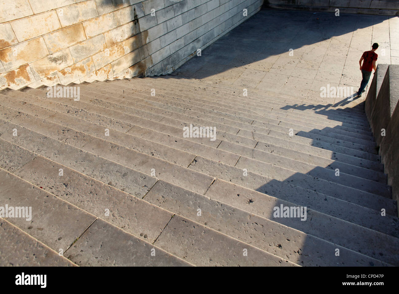 Persona che cammina giù per una scalinata in pietra, Parigi, Francia, Europa Foto Stock