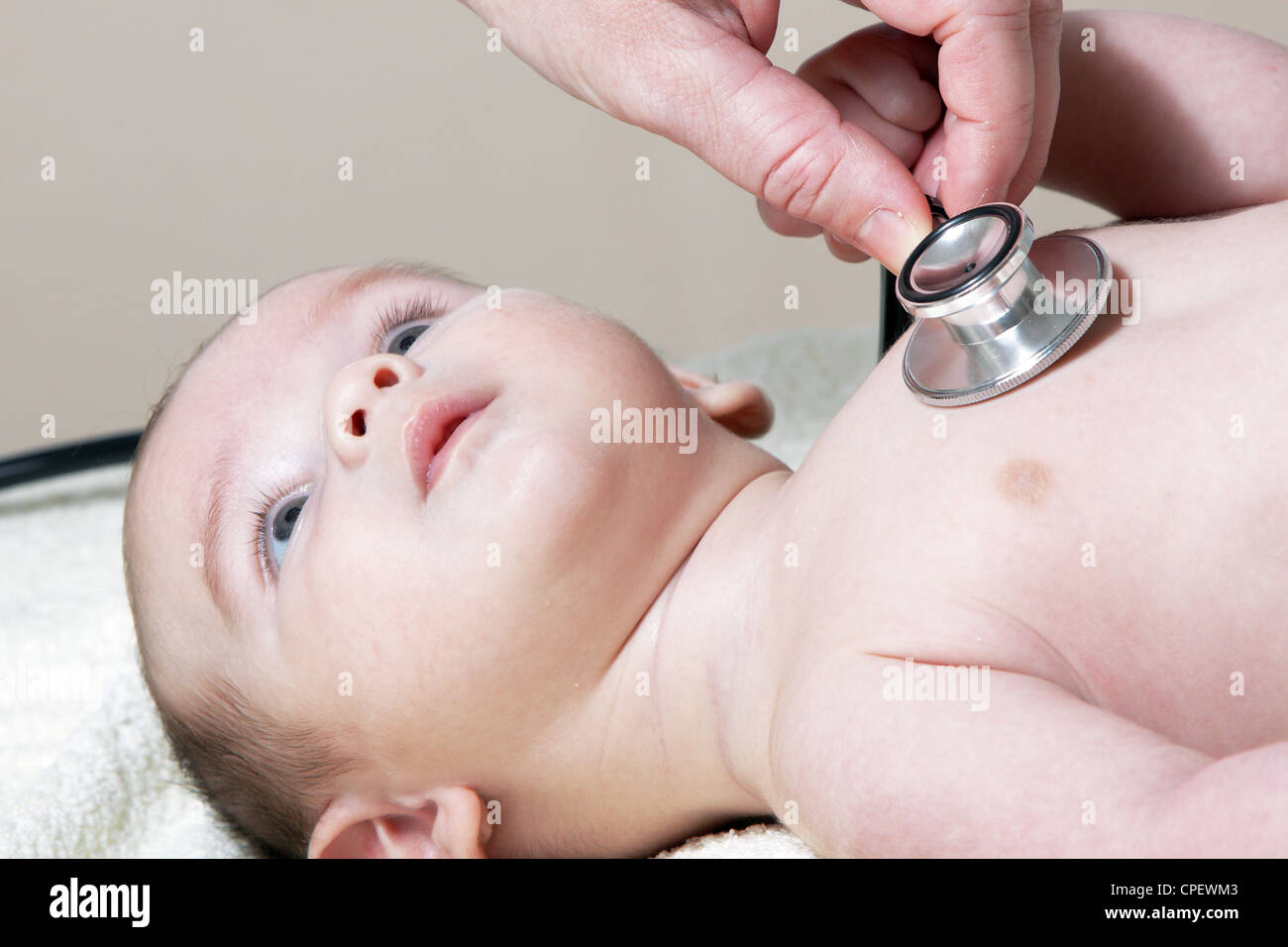 Uno stetoscopio in ascolto ad un bambino del battito cardiaco Foto Stock