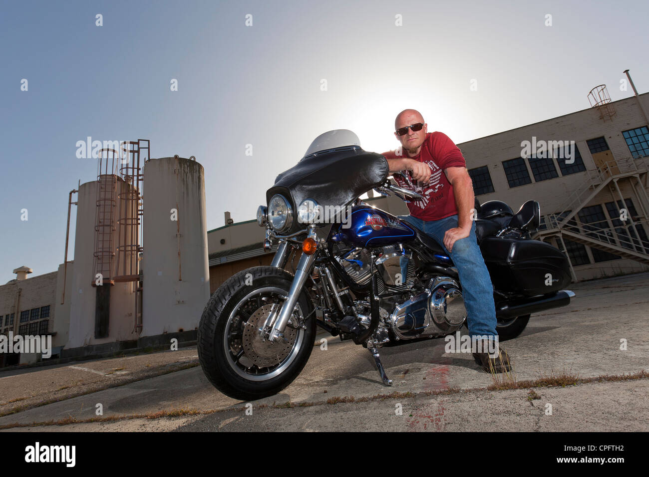 Una Harley Davidson motociclista seduto sulla sua moto Foto Stock