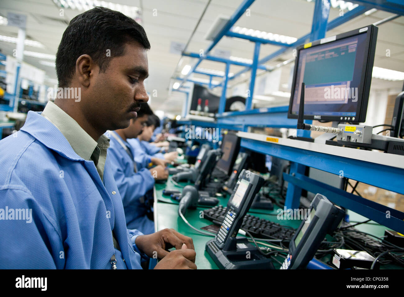 Test dei lavoratori hand-held computer di inventario dispositivi sulla linea di assemblaggio al Venture Corp. fabbrica in Singapore Foto Stock