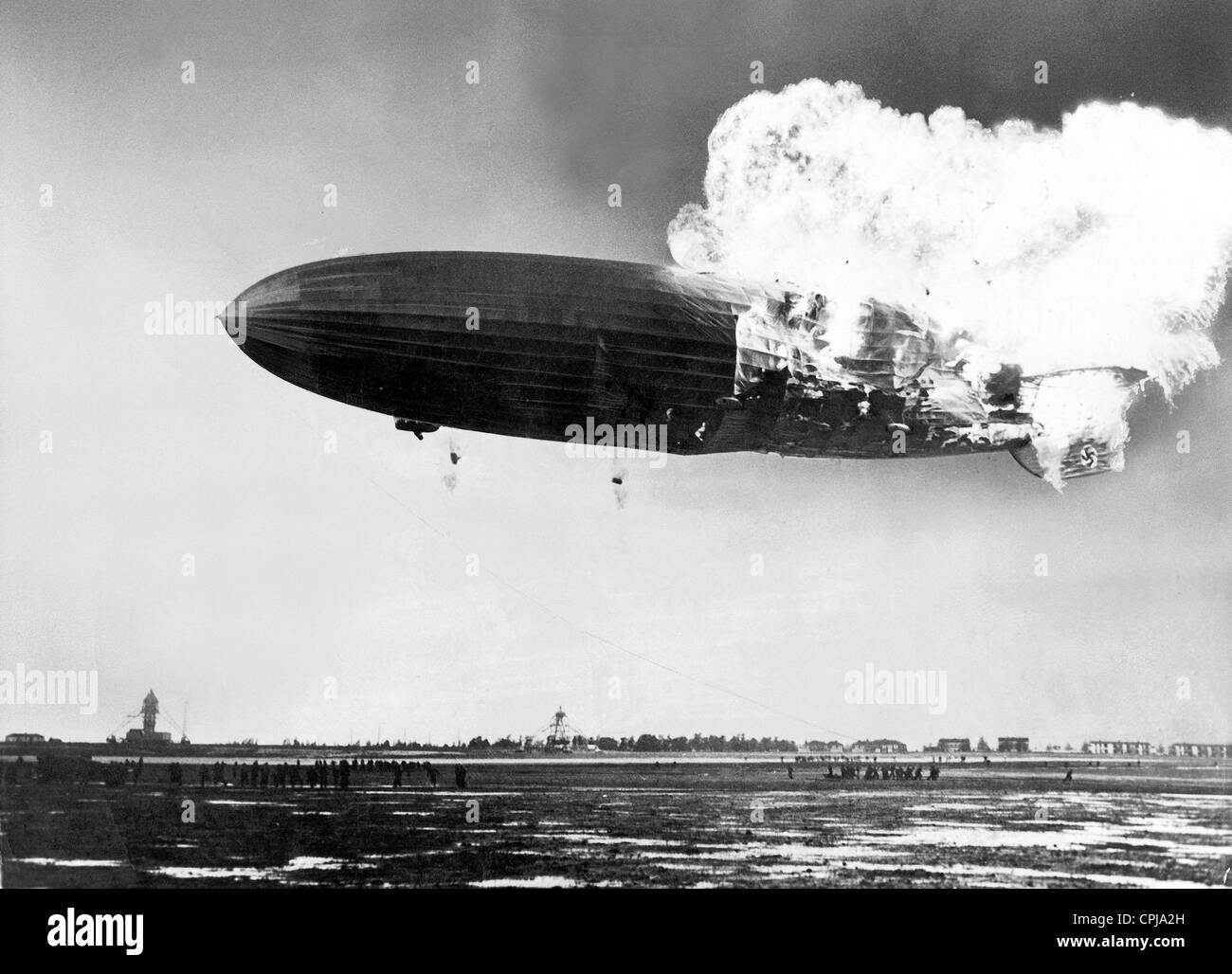 Image result for The Hindenburg took fire 200 feet above the ground as it approached the mooring post at the Naval Air Station in Lakehurst, New Jersey, in the evening of 6 May 1937