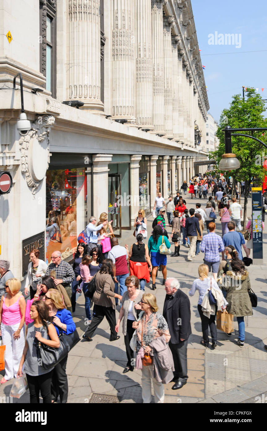 La trafficata Oxford Street, la folla di acquirenti, si affaccia dall'alto sul marciapiede accanto al grande magazzino Selfridges, via dello shopping, giorno estivo, Londra UK Foto Stock