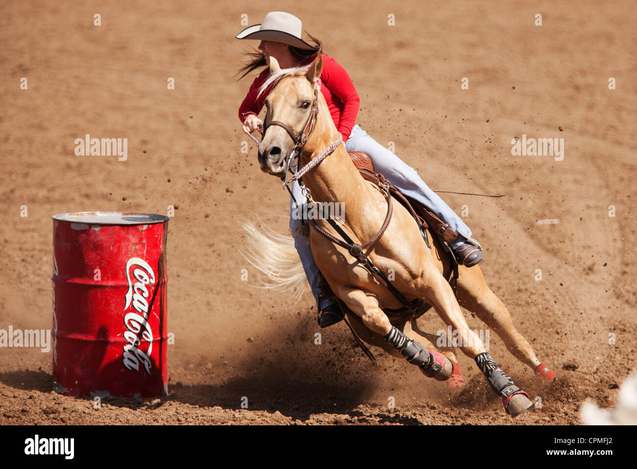 Un concorrente nella gara di corse barile compete al 90° rodeo annuale Black Hills Roundup a Belle Fourche, South Dakota. Foto Stock