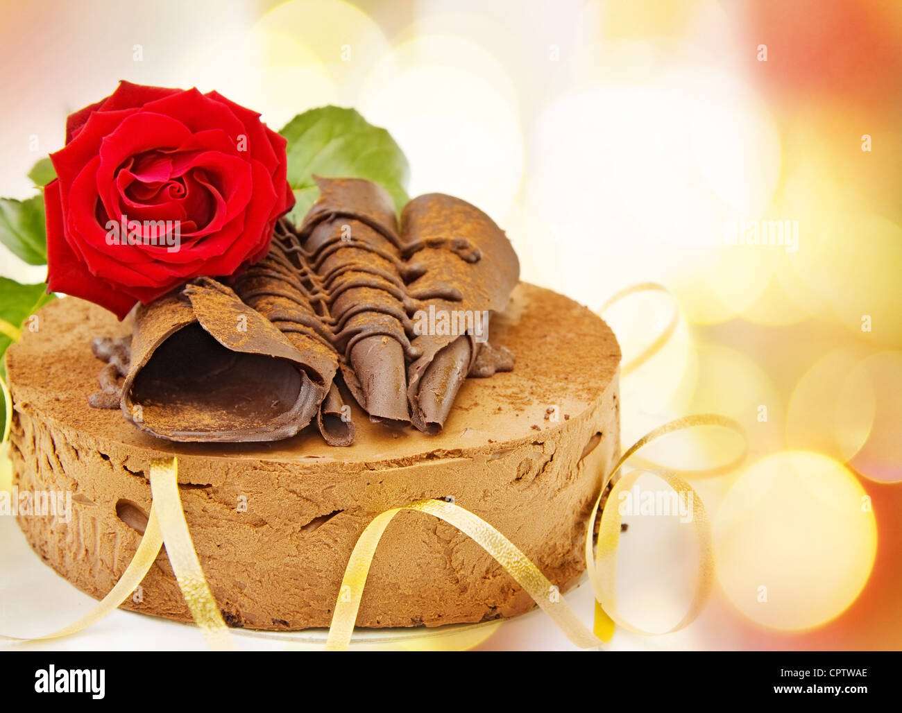 Buon compleanno card con torta Toffee e red rose su luci sfocati. Foto Stock