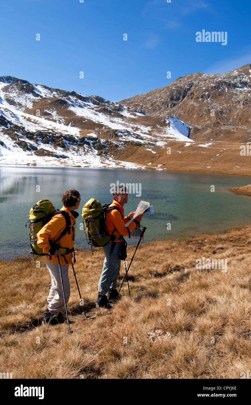 La Svizzera centrale delle Alpi della Val Bregaglia Cantone dei Grigioni gli escursionisti guardando su una mappa sul bordo di un lago sotto Septimer Pass Foto Stock