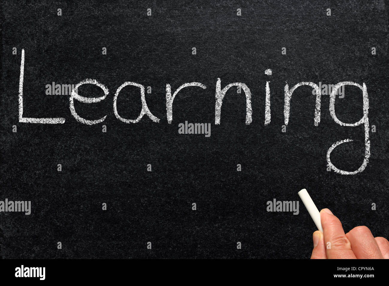 La scrittura di apprendimento su una lavagna. Foto Stock