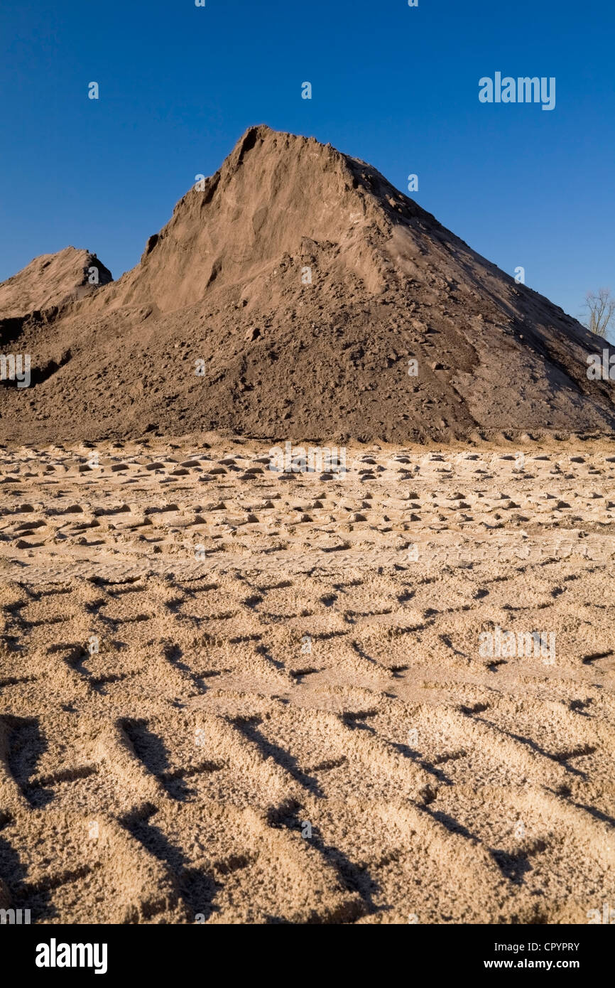 Pneumatici pesanti le vie che conducono a un cumulo di sabbia in una buca di sabbia commerciale, Quebec, Canada Foto Stock