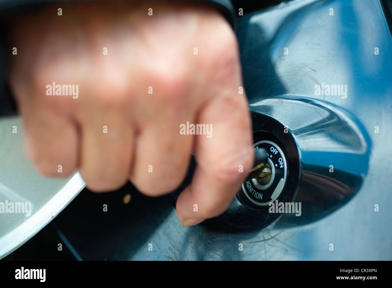 Biker femminile utilizzando la chiave di accensione per avviare il motore del motociclo Foto Stock