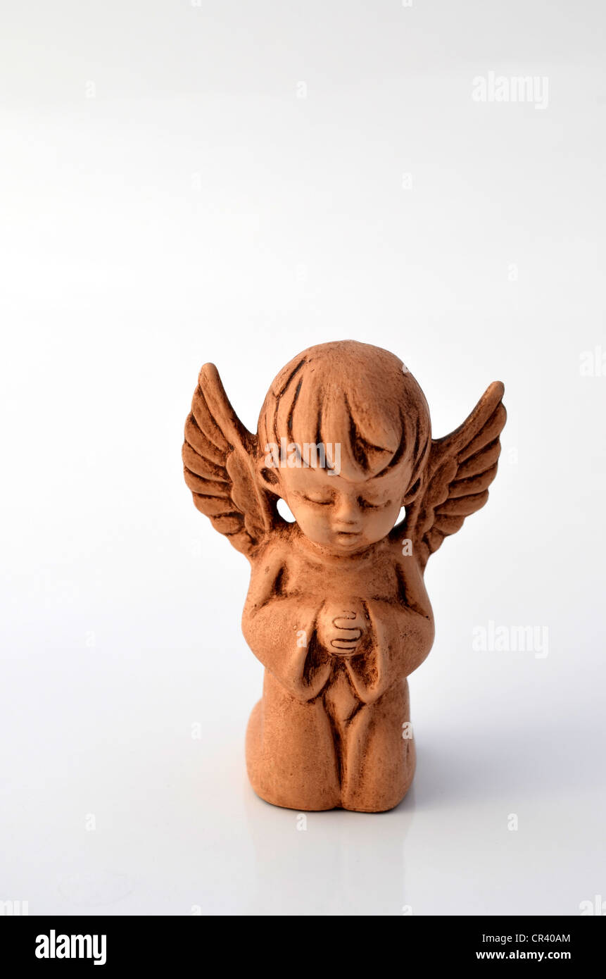 Little Angel fatti di argilla, pregando Foto Stock