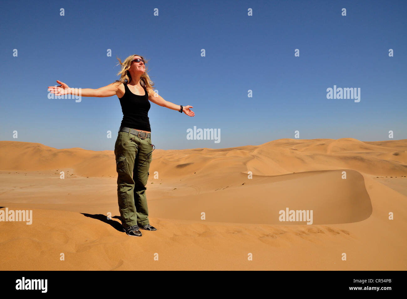 Tourist allargando le braccia, dune vicino a Swakopmund, Namibia, Africa Foto Stock