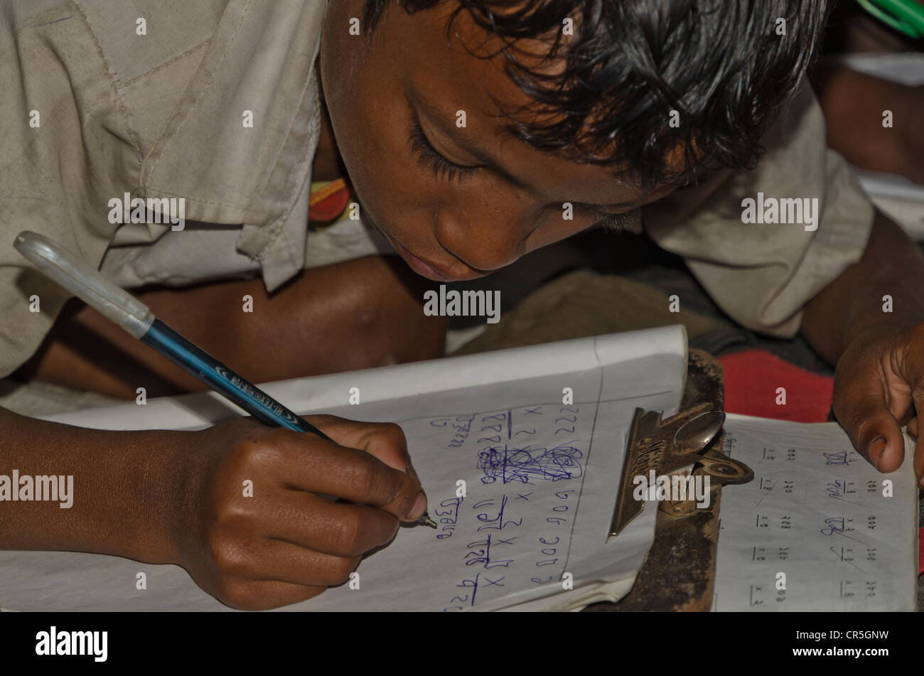 Bambino nella scuola di governo in Borbil ancora molti studi sul pavimento, India, Asia Foto Stock