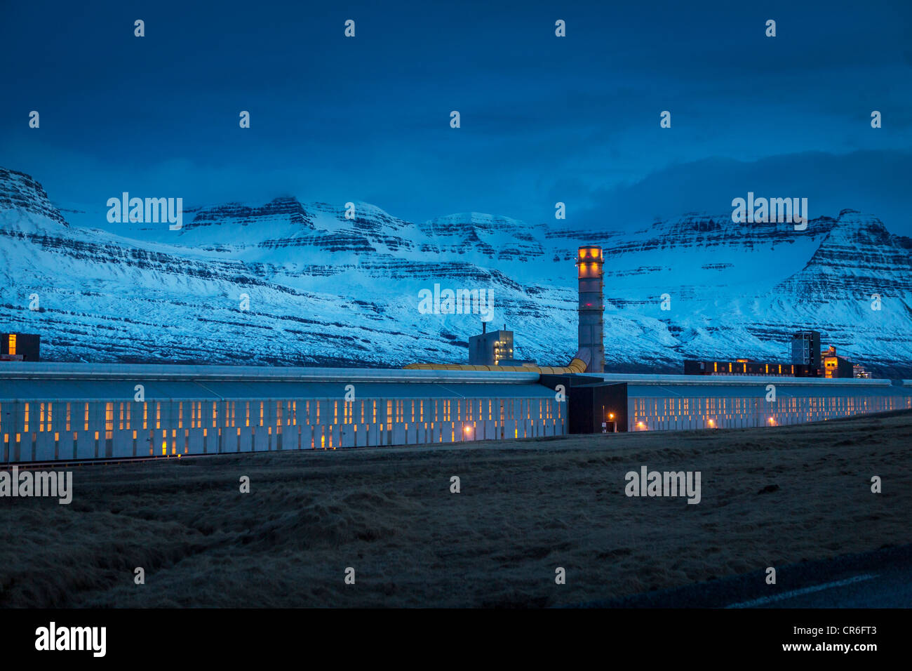 Luce invernale, smelter di alluminio alimentato da energia geotermica, Faskrudsfjordur Islanda Foto Stock