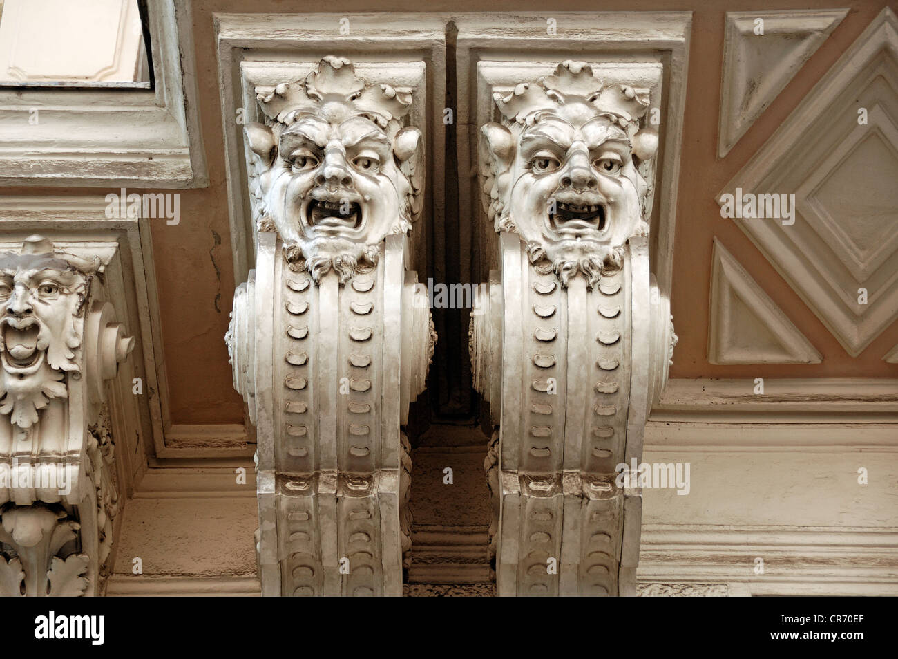 Due grottesche, statue, sotto il balcone di stile liberty della casa di città, costruita intorno al 1900, Gruenangergasse street 2 Foto Stock