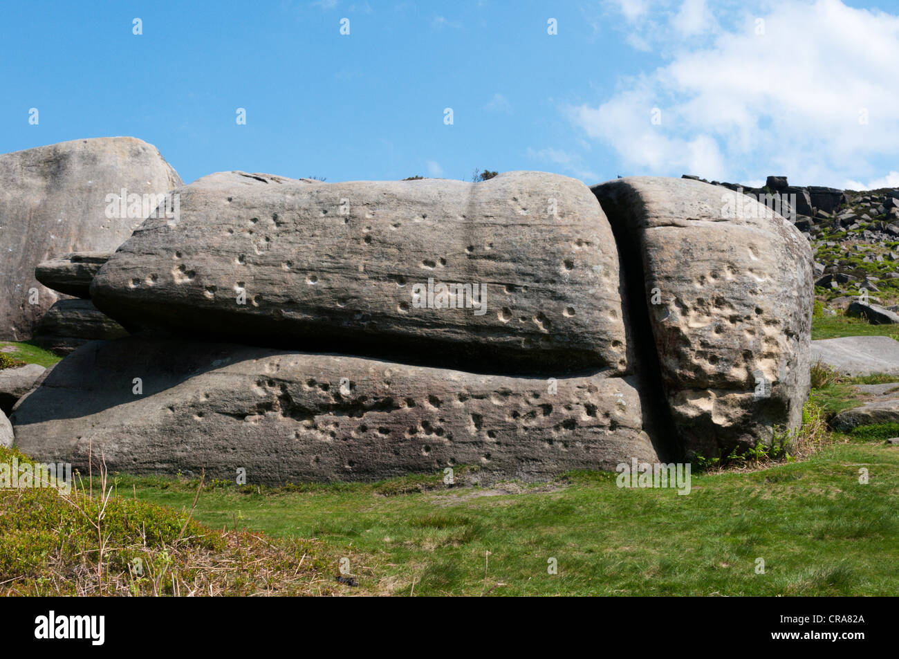 Questi marchi in un masso a Burbage rocce in inglese del Peak District, sono fori di proiettile dall esercito di formazione esercizi nella seconda guerra mondiale. Foto Stock