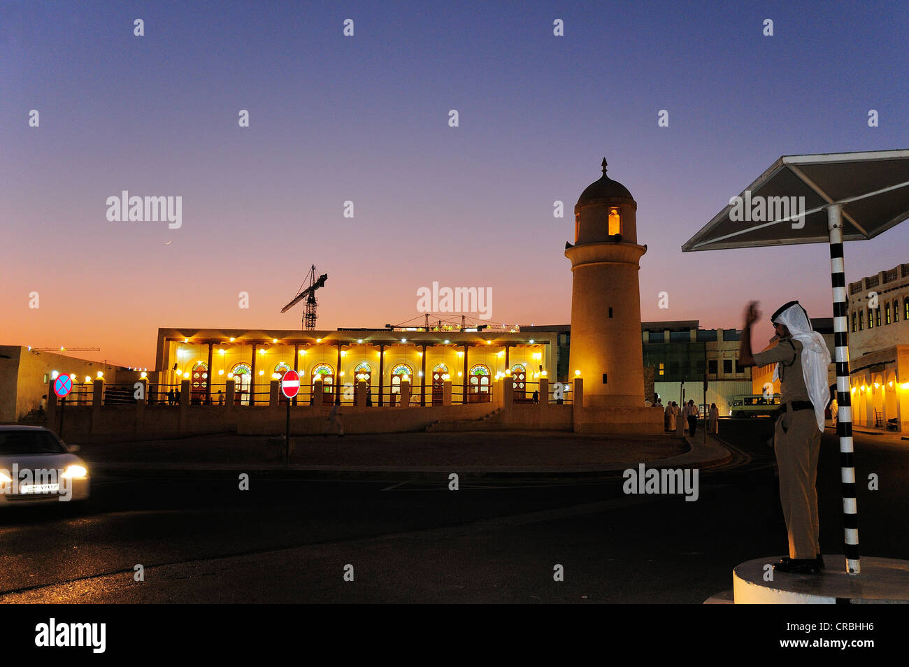 Funzionario di polizia dirigere traffico al di fuori della moschea nel Souk Waqik, Doha, Qatar Foto Stock