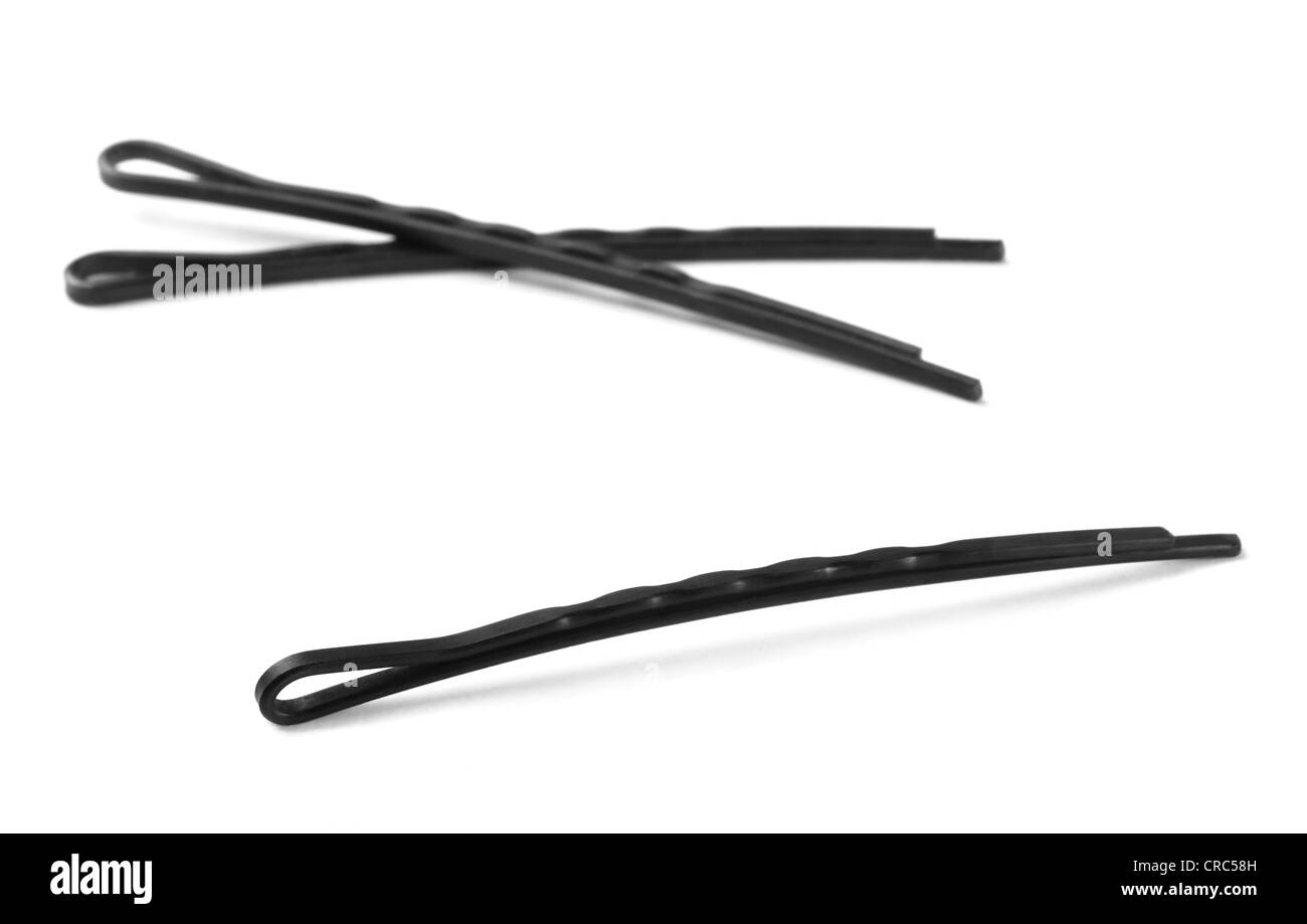 Tre di metallo nero capelli bobby pin isolato su bianco Foto Stock