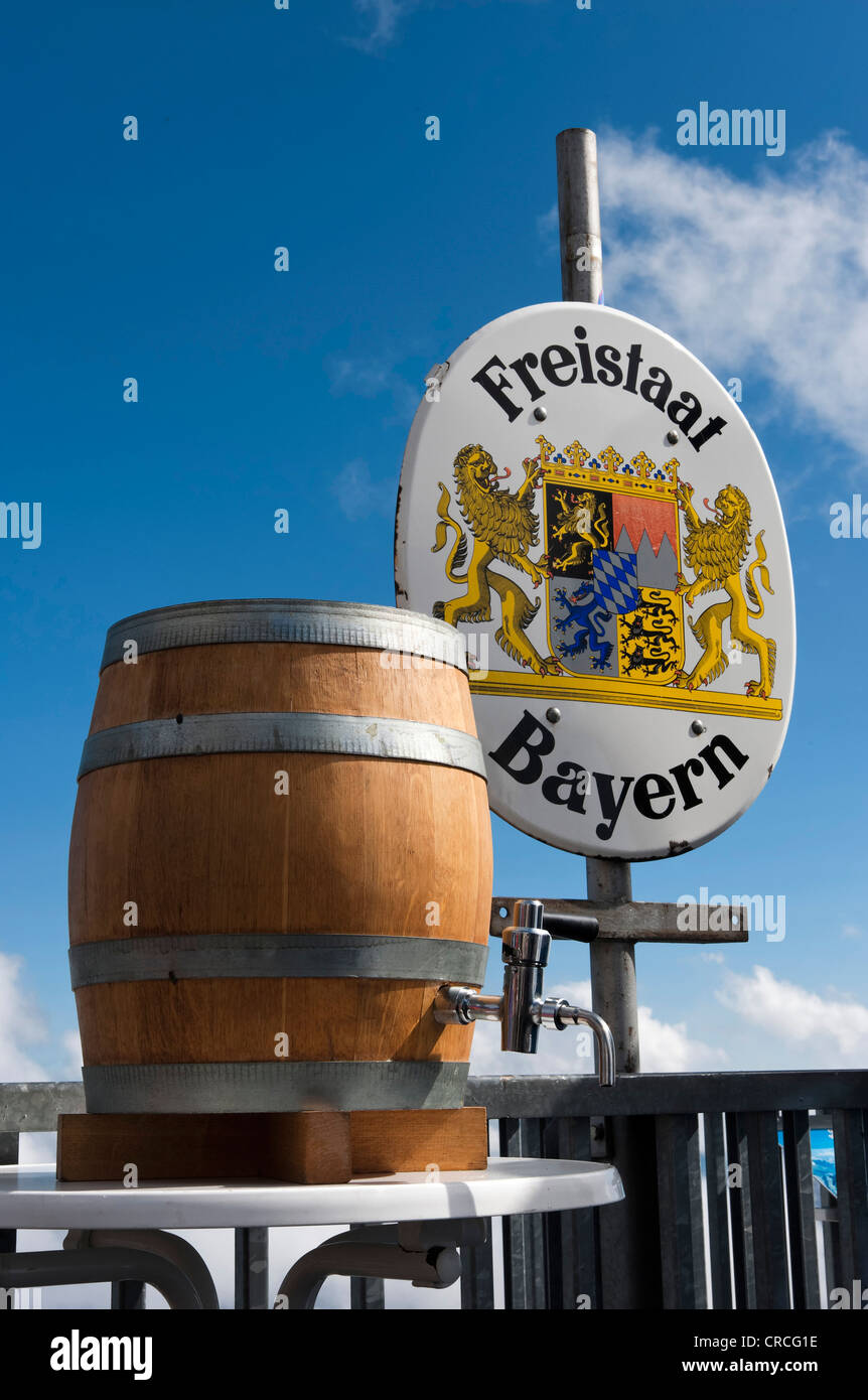 Un barile di birra in piedi di fronte a un segno di confine del Freistaat Bayern o dello Stato libero di Baviera, stazione a monte vicino alla Foto Stock