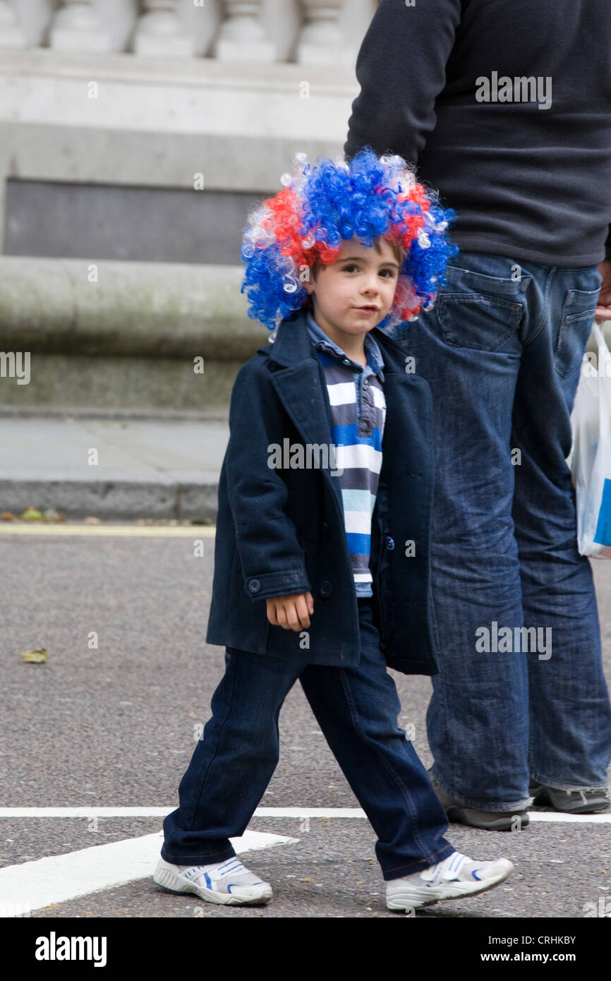 Little Boy in una unione jack parrucca sulle strade pf London Inghilterra England Foto Stock