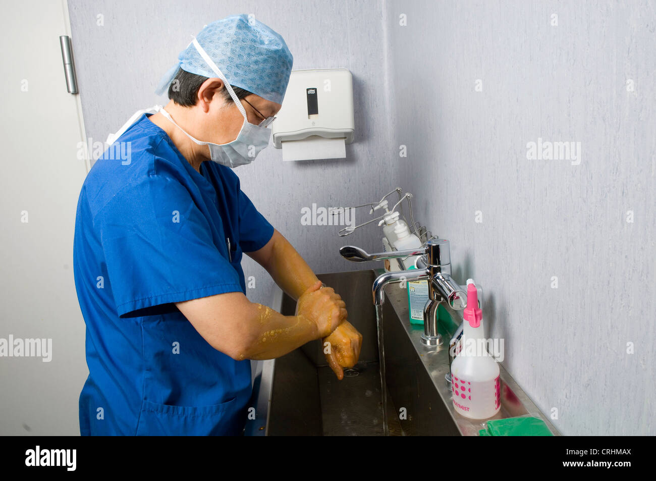 Un medico si lava le mani come parte della procedura prima e dopo la chirurgia. Foto Stock