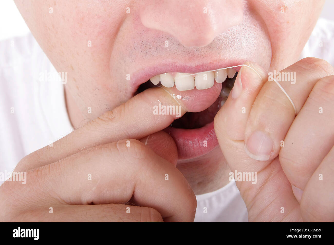 Per le cure dentarie con filo interdentale, igiene orale Foto Stock