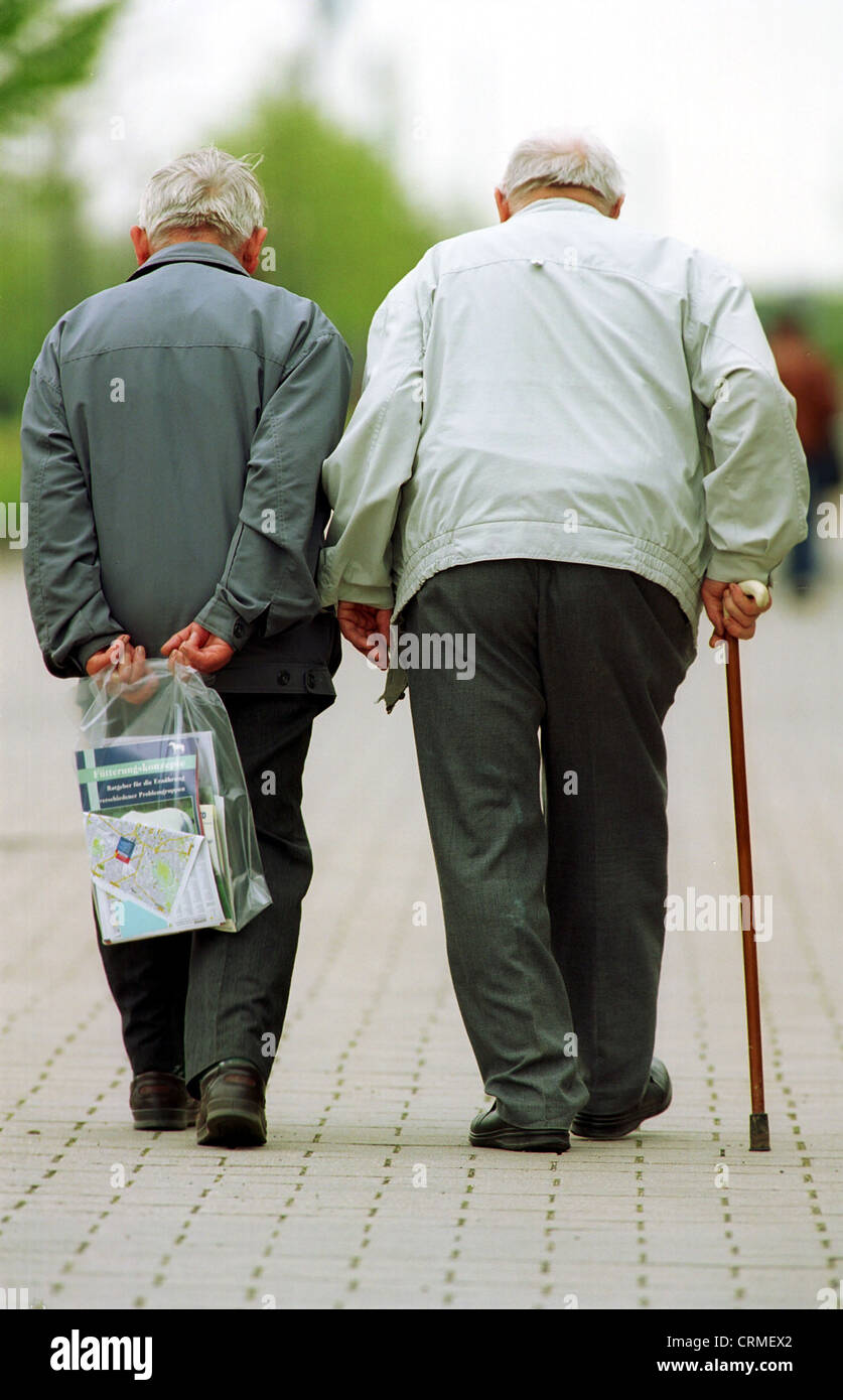 Due anziani a camminare sulla strada Foto Stock