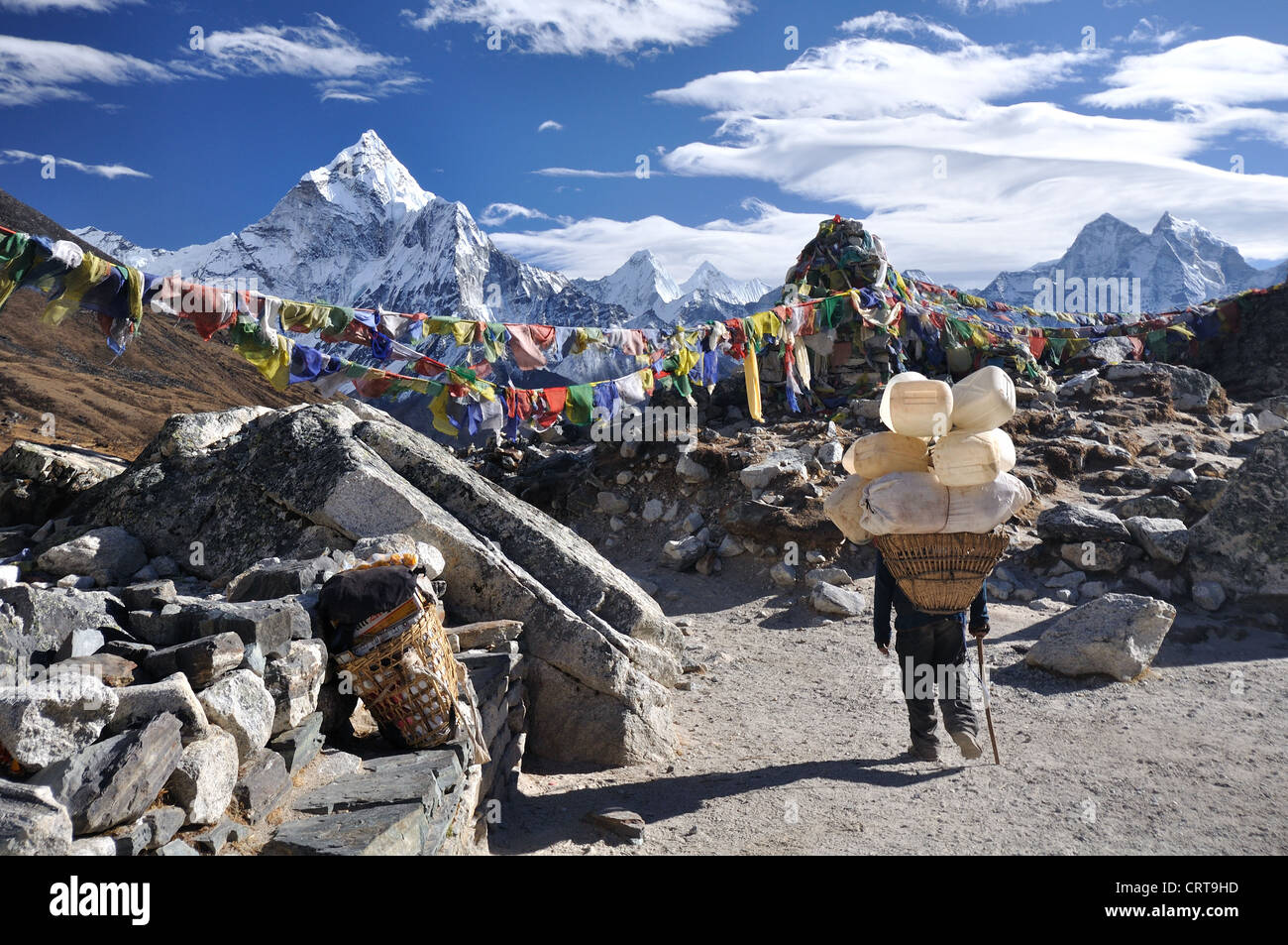 Il nepalese porter rende la sua strada verso il basso il Thokla Pass nella regione dell Everest del Nepal Foto Stock