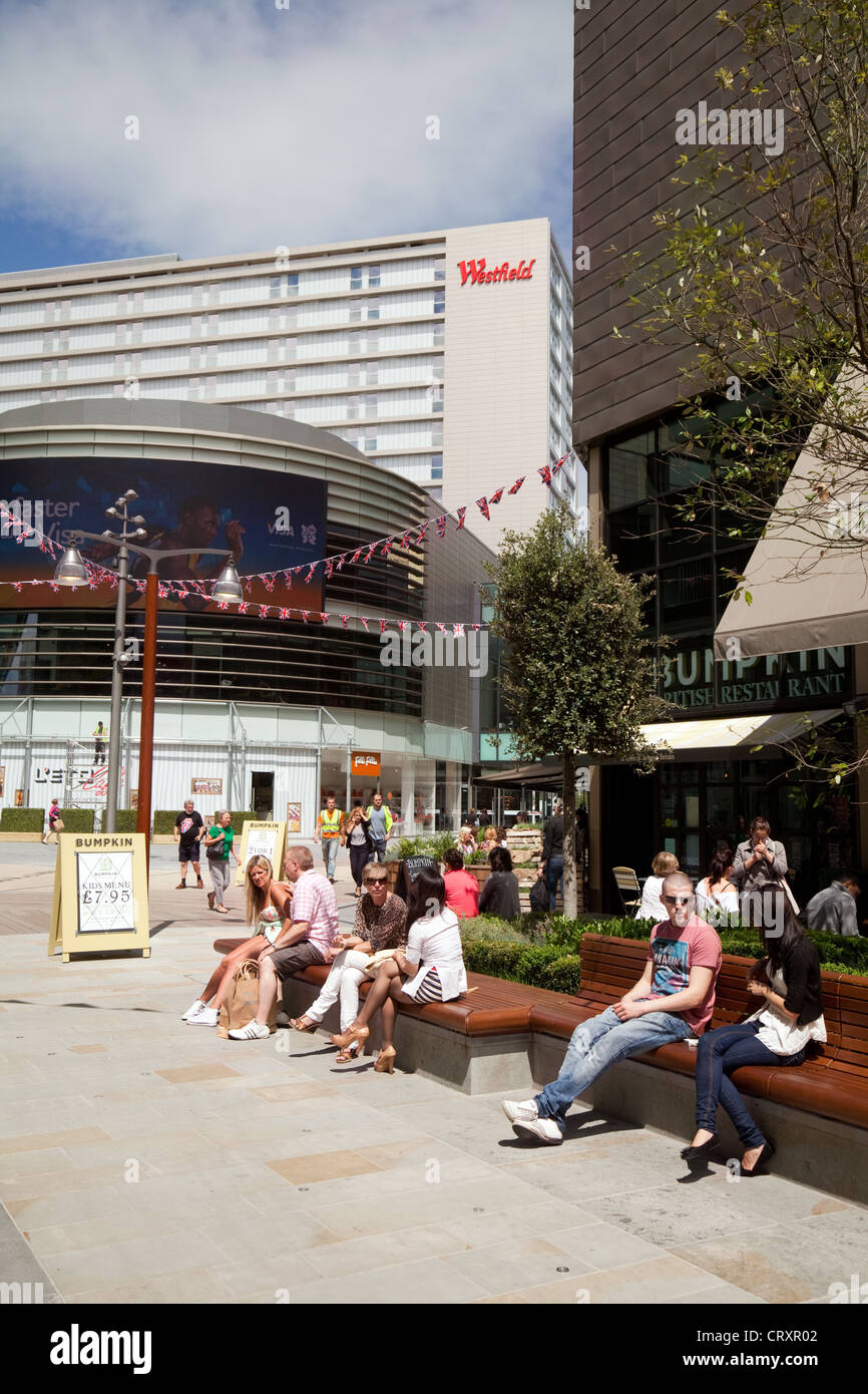 La gente seduta nel centro commerciale Westfield Stratford London REGNO UNITO Foto Stock