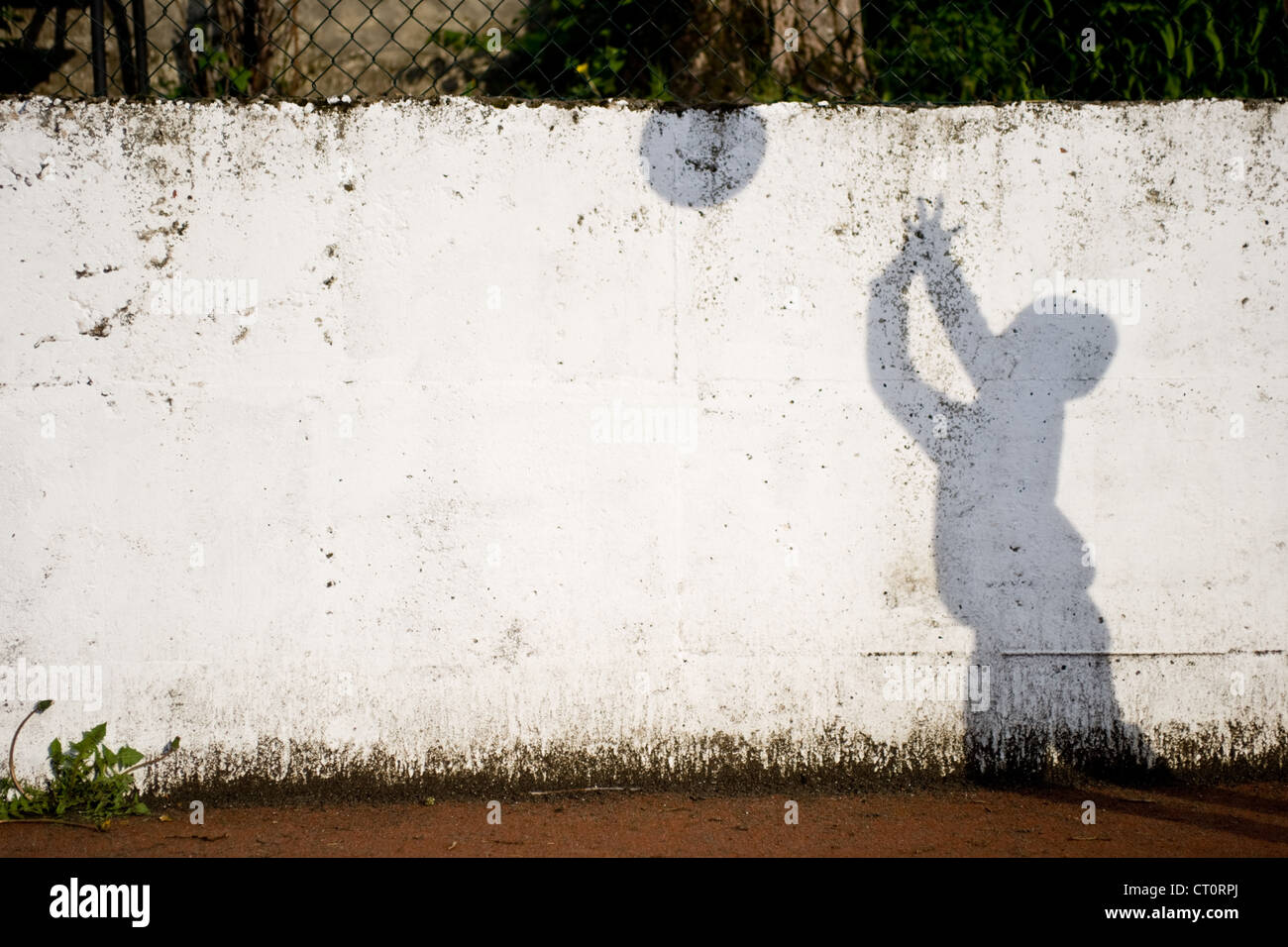 Ombra di un ragazzo sulla parete giocare a palla. Foto Stock