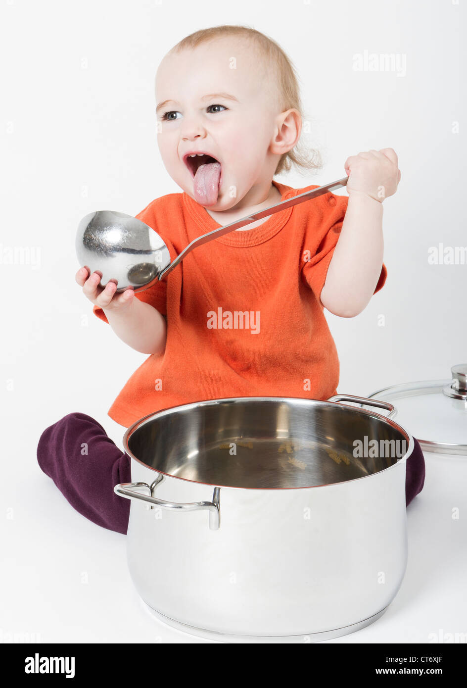 Bambino con grande pentola di cottura isolata su sfondo neutro Foto Stock