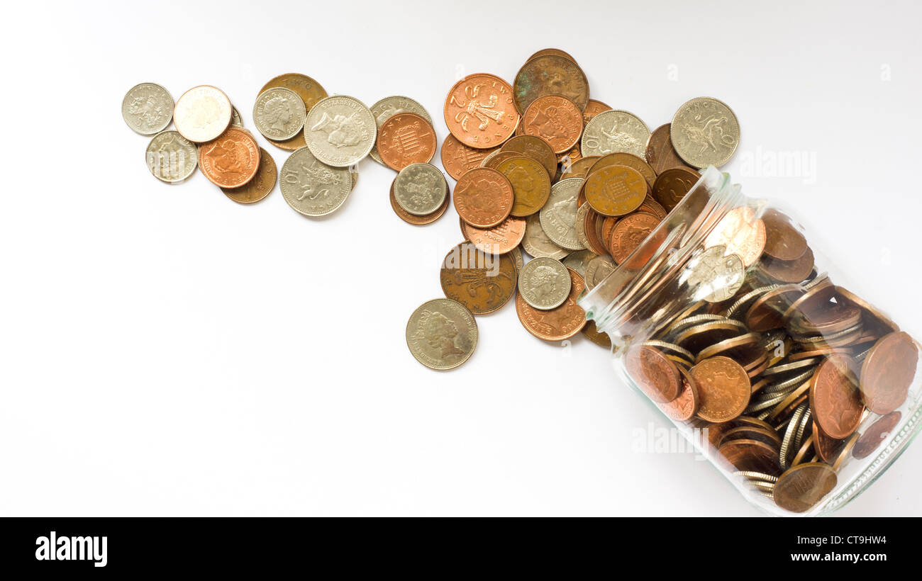 Il denaro di vetro vaso con monete Foto Stock