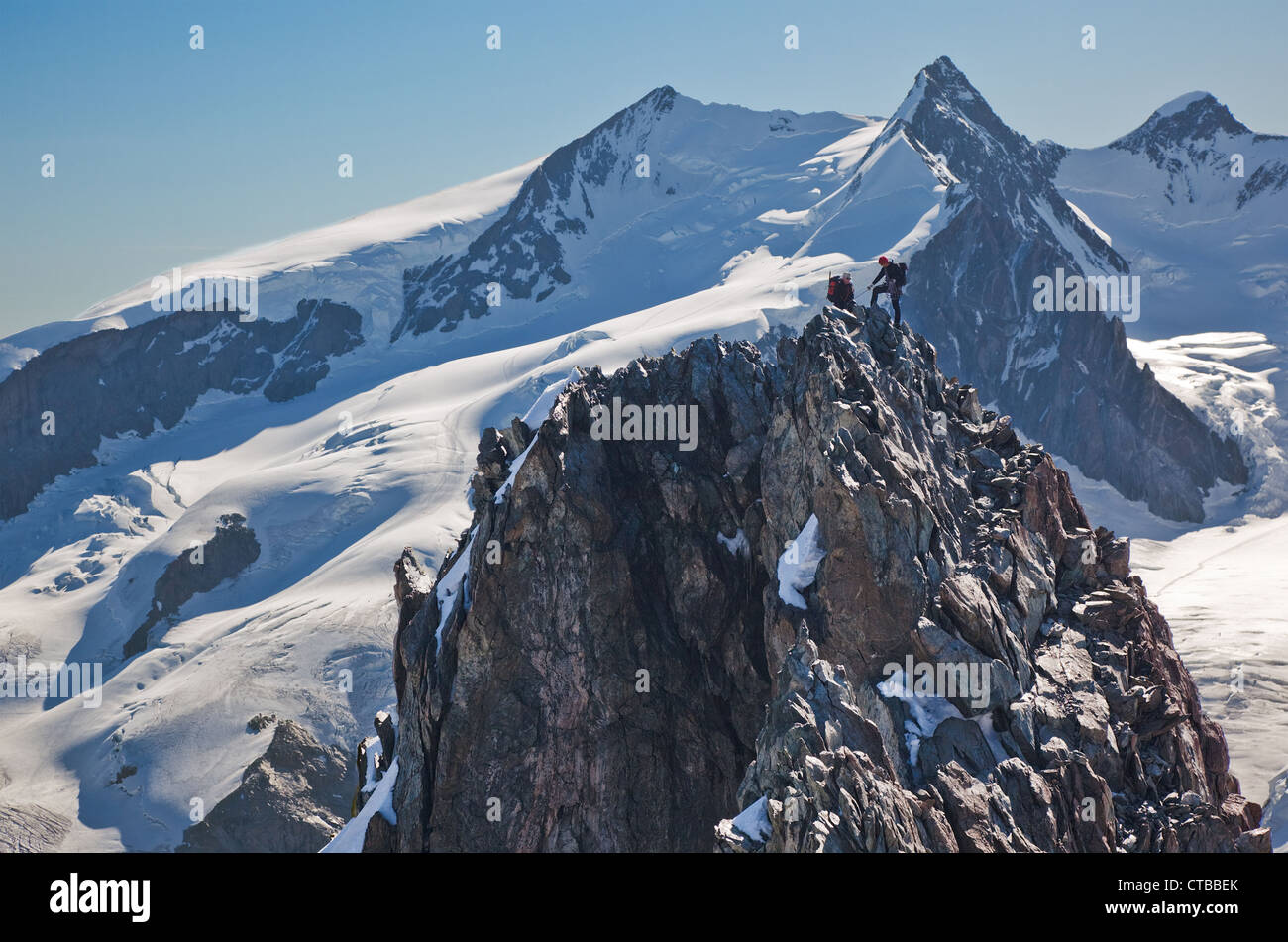 Due mountaneers salire ridge Breithorn esattamente su swiss-confine italiano in background principali cime del Monte Rosa massiccio 4650 mt secondo Foto Stock