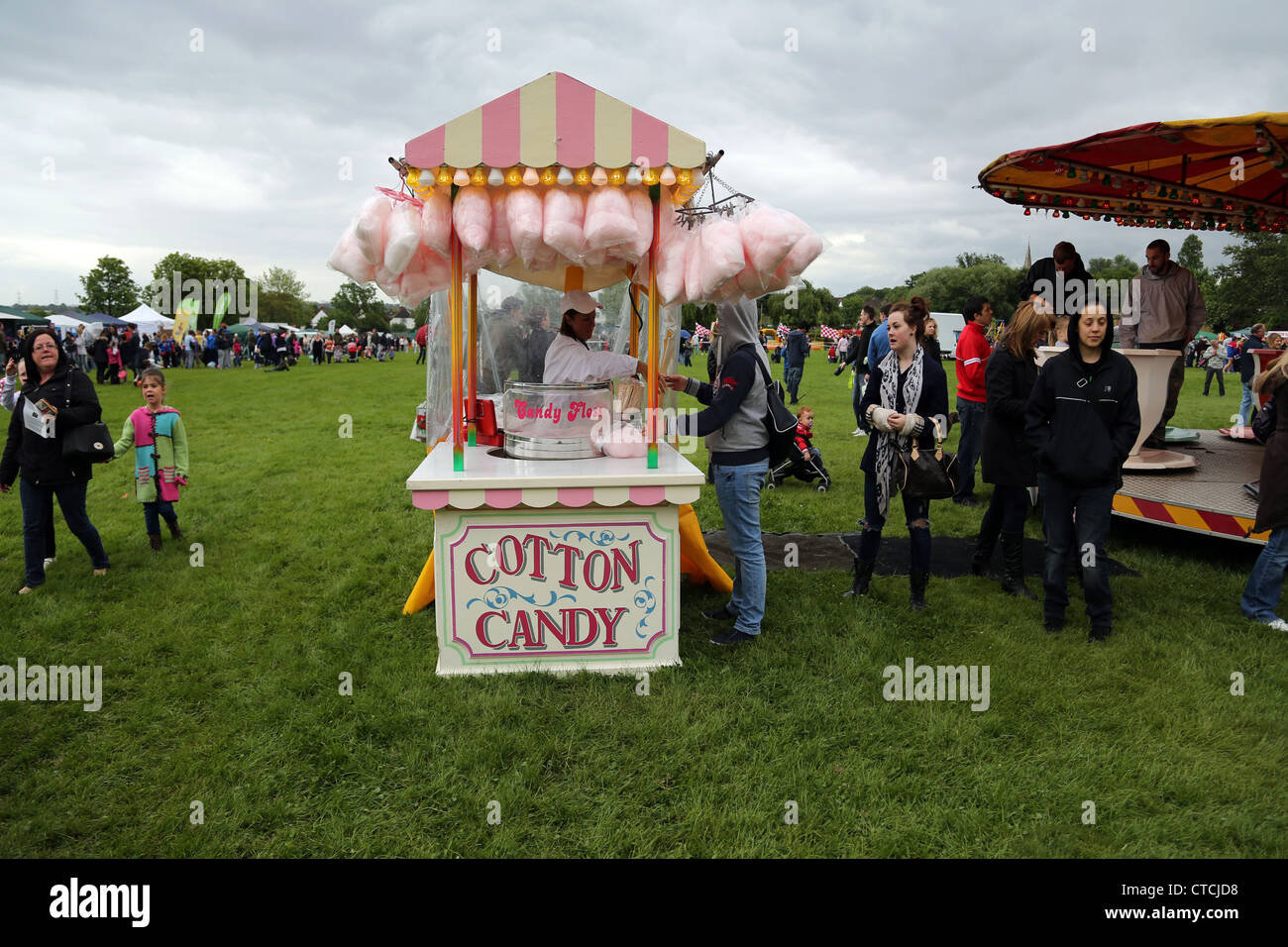 Donna acquisto caramella di cotone dal venditore al villaggio CHEAM SURREY FAIR in Inghilterra Foto Stock